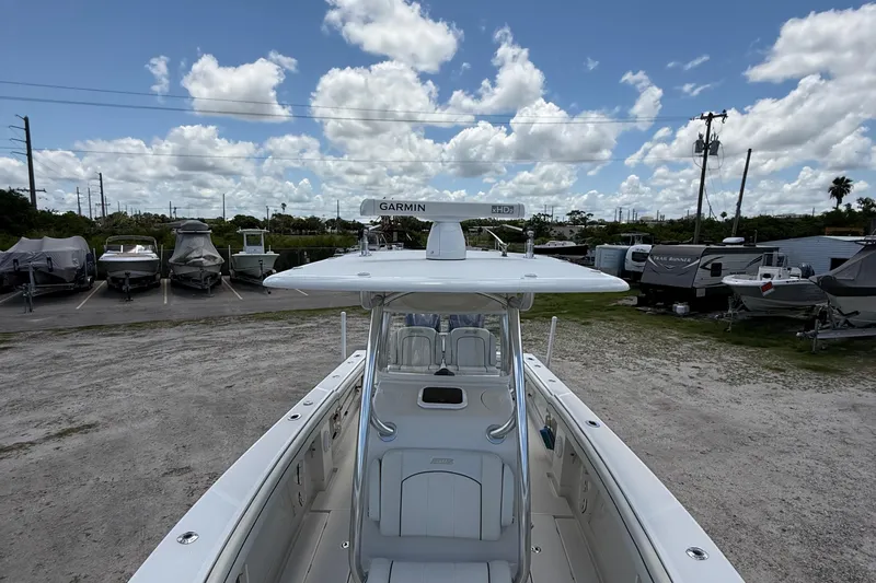  Yacht Photos Pics 2014 Jupiter 30 FS boat with Garmin radar, parked in a lot under a cloudy sky.