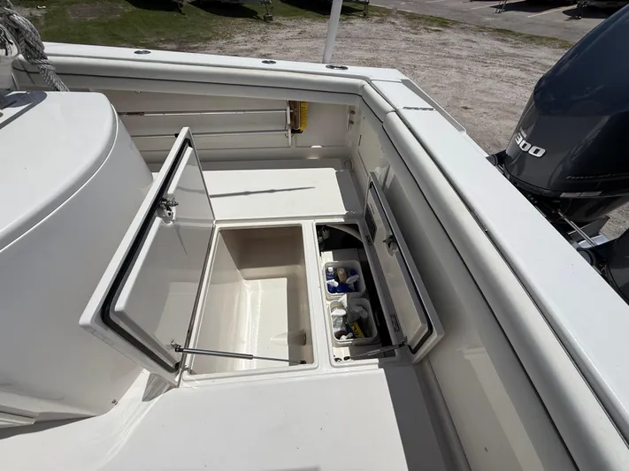  Yacht Photos Pics 2014 Jupiter 30 FS boat storage compartments with open hatches and visible engine.