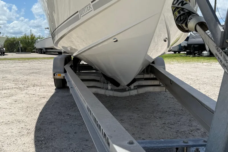  Yacht Photos Pics 2014 Jupiter 30 FS boat on trailer, parked outdoors under a blue sky.