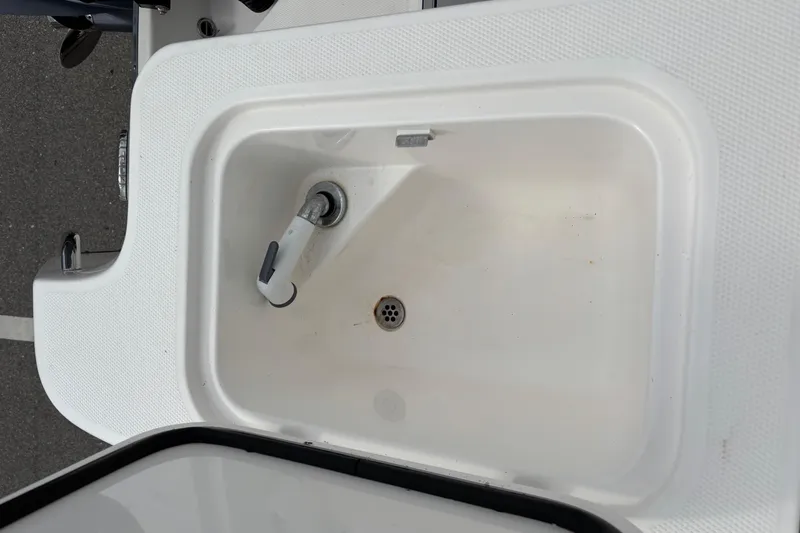 Liberty Call Yacht Photos Pics Edgewater 320CC 2015 boat sink with faucet, white basin, and drain.