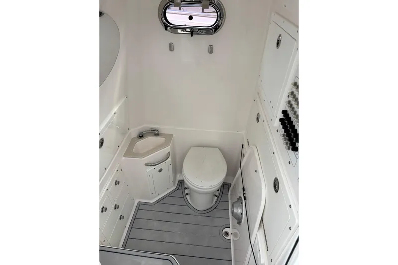 Liberty Call Yacht Photos Pics 2015 Edgewater 320CC boat interior bathroom with toilet and sink.