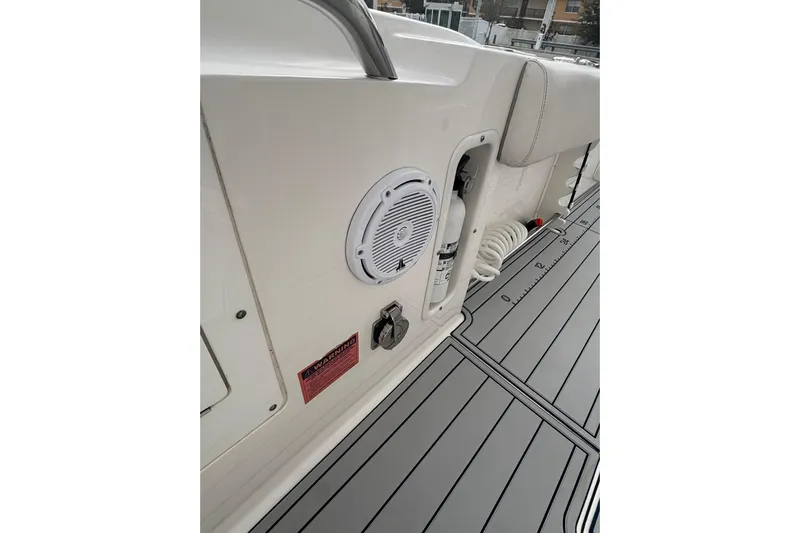 Liberty Call Yacht Photos Pics 2015 Edgewater 320CC boat interior with speaker, fire extinguisher, and coiled hose.
