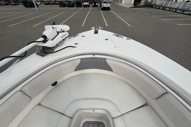 Liberty Call Yacht Photos Pics 2015 Edgewater 320CC boat with Garmin equipment, parked in a lot, featuring white seating.
