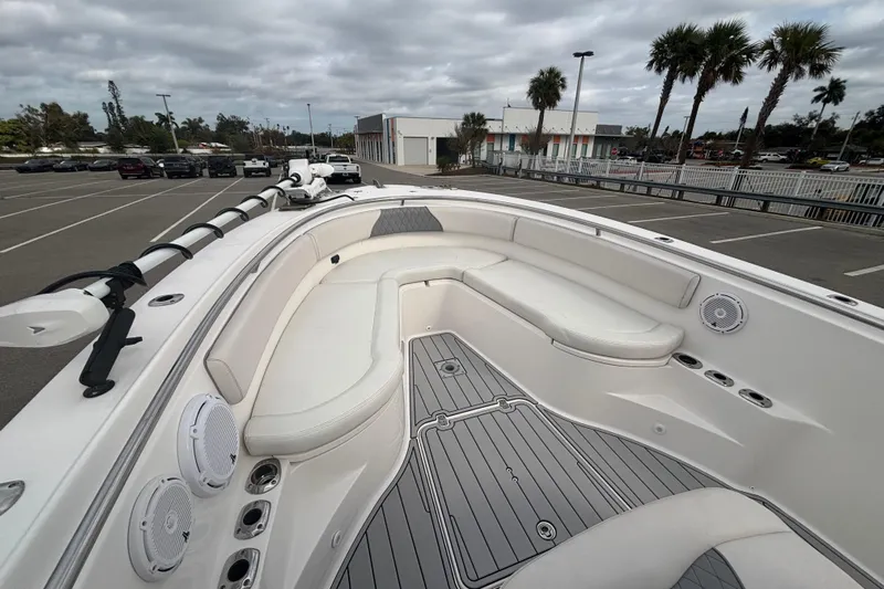 Liberty Call Yacht Photos Pics 2015 Edgewater 320CC boat interior with white seating and gray flooring in a parking lot.