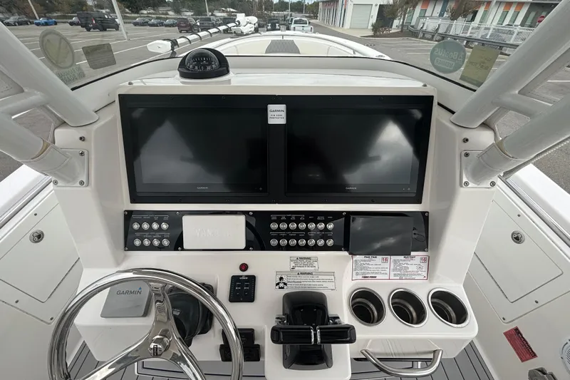 Liberty Call Yacht Photos Pics 2015 Edgewater 320CC boat dashboard with Garmin displays and steering wheel.