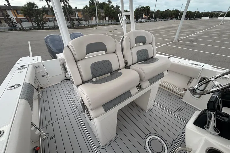 Liberty Call Yacht Photos Pics 2015 Edgewater 320CC boat interior with dual cushioned seats and sleek design.