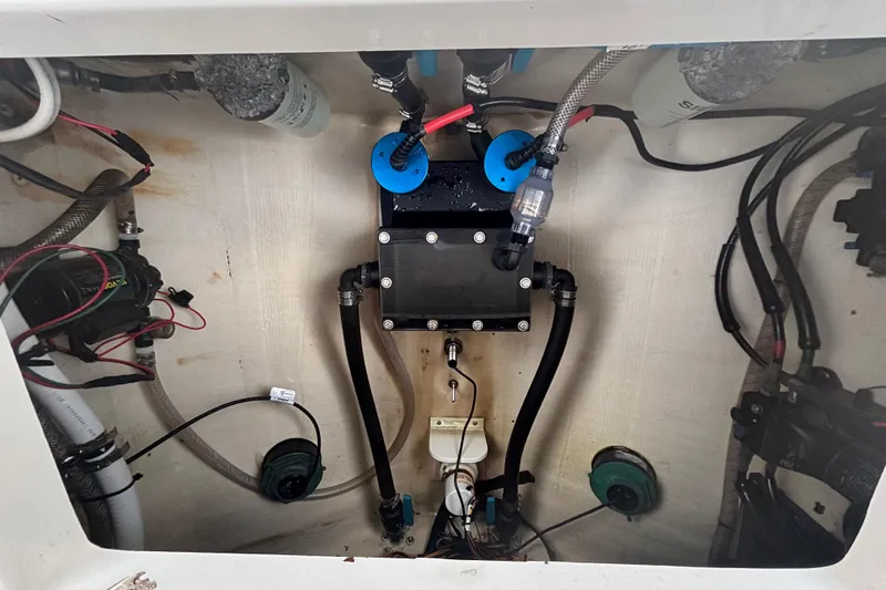 Liberty Call Yacht Photos Pics Interior view of 2015 Edgewater 320CC boat's engine compartment with wiring and components.