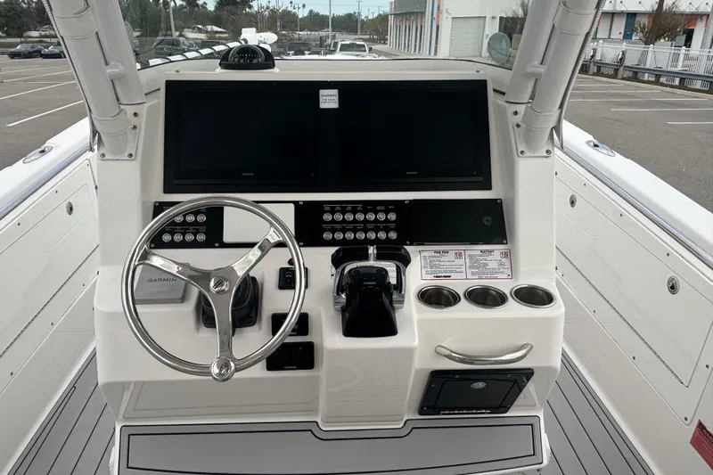 Liberty Call Yacht Photos Pics Center console of a 2015 Edgewater 320CC boat with steering wheel and controls.