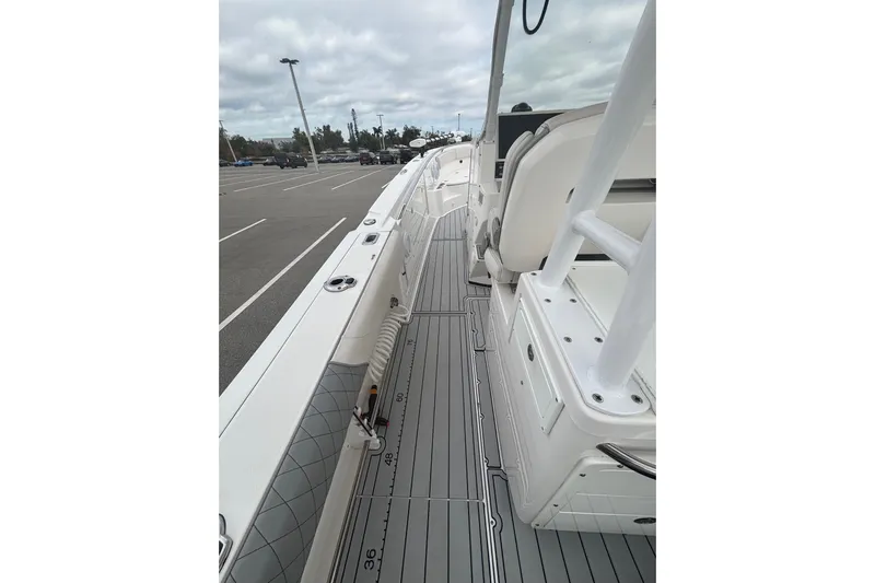 Liberty Call Yacht Photos Pics 2015 Edgewater 320CC boat interior with sleek deck design in a parking lot setting.