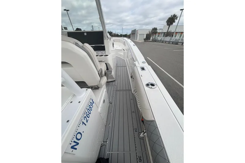 Liberty Call Yacht Photos Pics 2015 Edgewater 320CC boat interior with seating and deck view.