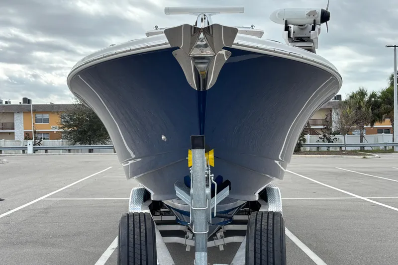 Liberty Call Yacht Photos Pics Front view of a 2015 Edgewater 320CC boat on a trailer in a parking lot.