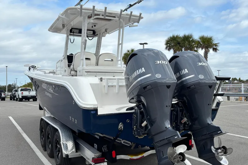 Liberty Call Yacht Photos Pics 2015 Edgewater 320CC boat with dual Yamaha 300 engines, parked on a trailer.