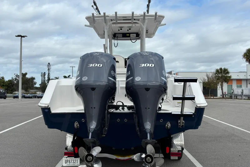 Liberty Call Yacht Photos Pics 2015 Edgewater 320CC boat with dual Yamaha 300 engines in a parking lot.