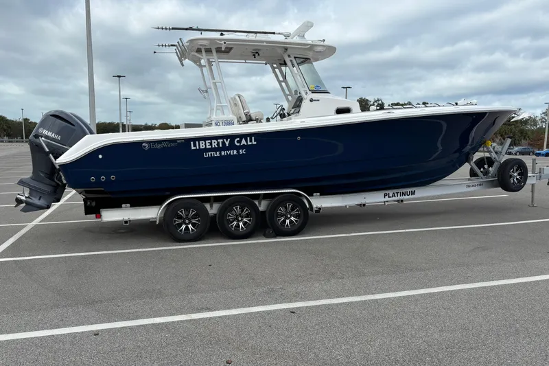 Liberty Call Yacht Photos Pics 2015 Edgewater 320CC boat on trailer in parking lot, side view.