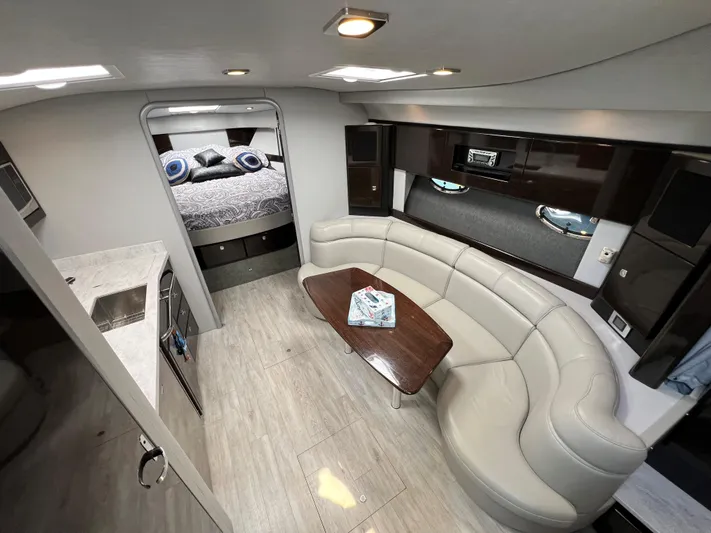  Yacht Photos Pics 2017 Formula 37 Performance Cruiser interior with modern kitchen, curved sofa, and cozy bedroom.