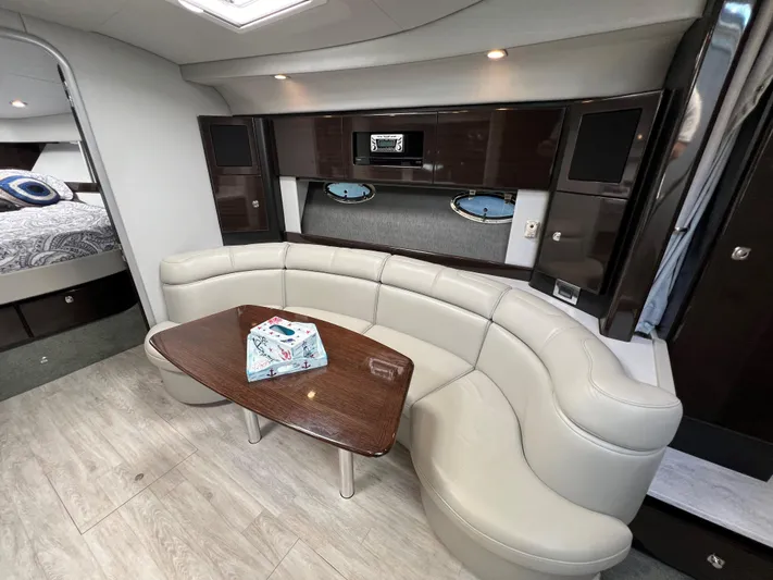  Yacht Photos Pics 2017 Formula 37 Performance Cruiser interior with curved seating and wooden table.