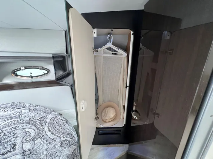  Yacht Photos Pics 2017 Formula 37 Performance Cruiser cabin closet with hanging clothes and hat.