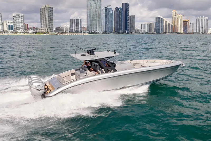  Yacht Photos Pics 2018 Midnight Express 43 Open boat cruising near city skyline on a sunny day.