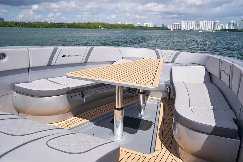  Yacht Photos Pics 2018 Midnight Express 43 Open boat with sleek seating and table on deck.