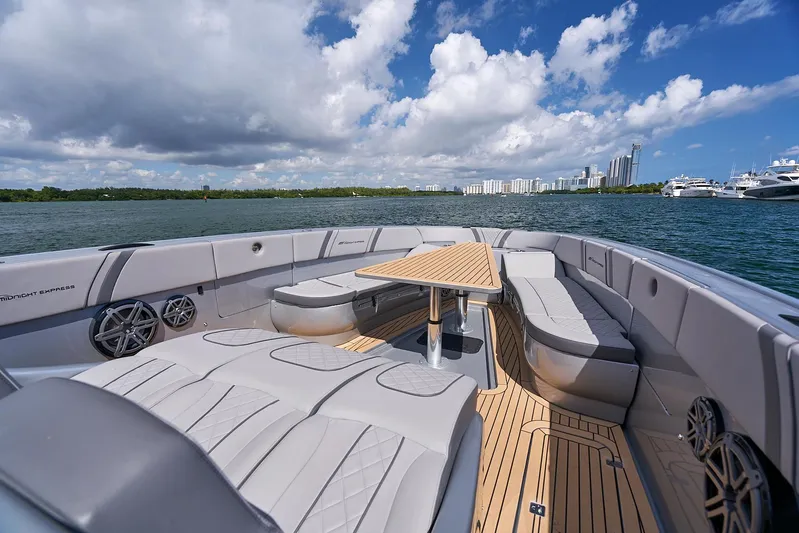  Yacht Photos Pics 2018 Midnight Express 43 Open boat with spacious seating and table on a sunny day.