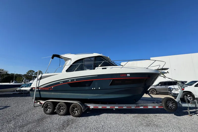  Yacht Photos Pics 2020 Beneteau Antares 27 boat on trailer, parked outdoors under clear blue sky.
