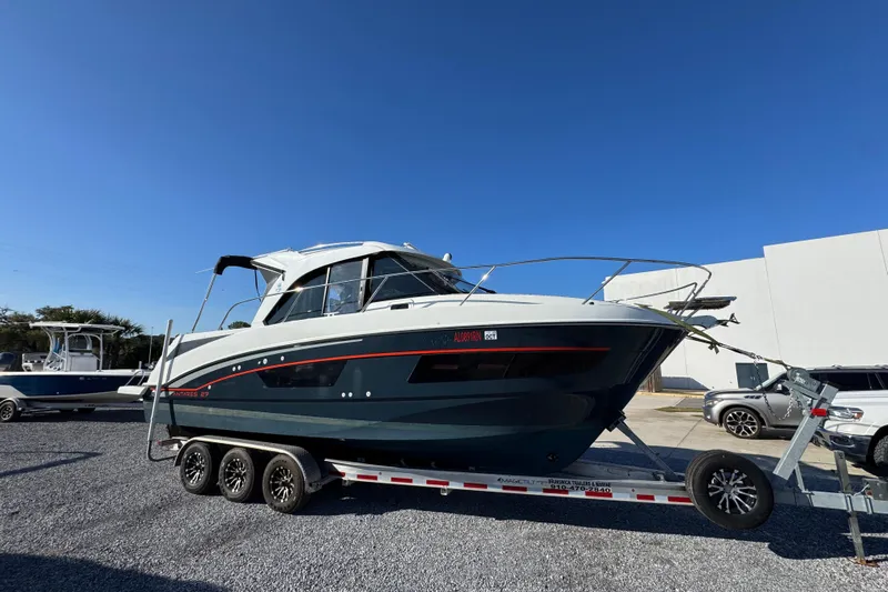  Yacht Photos Pics 2020 Beneteau Antares 27 boat on trailer under clear blue sky.