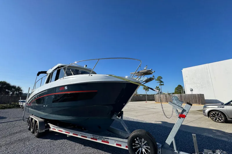  Yacht Photos Pics 2020 Beneteau Antares 27 boat on trailer under clear blue sky.