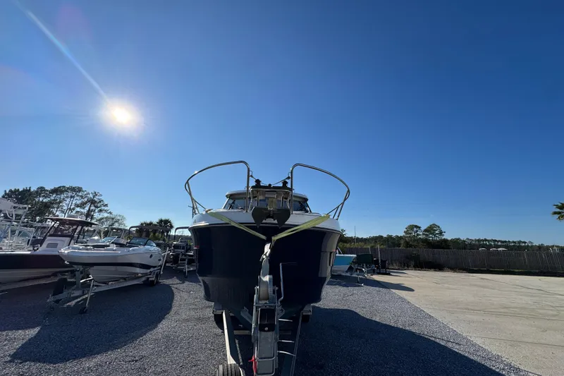  Yacht Photos Pics 2020 Beneteau Antares 27 boat under clear blue sky in a marina.