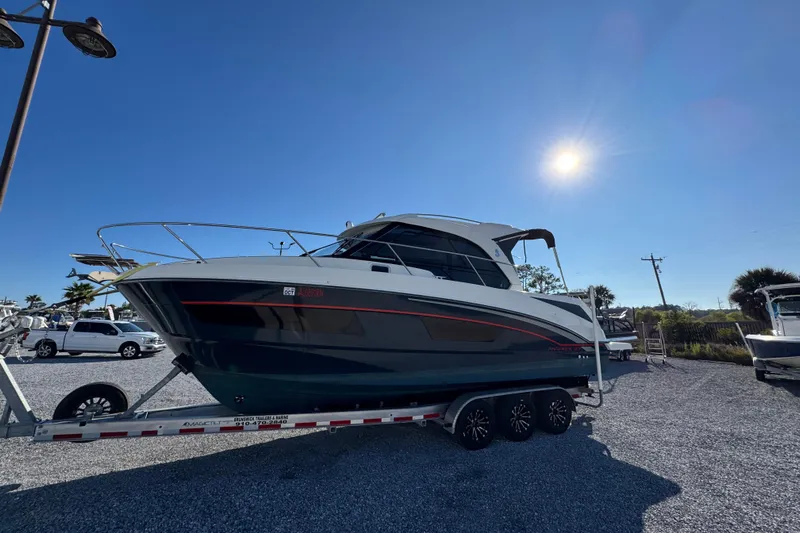  Yacht Photos Pics 2020 Beneteau Antares 27 boat on trailer under clear blue sky.