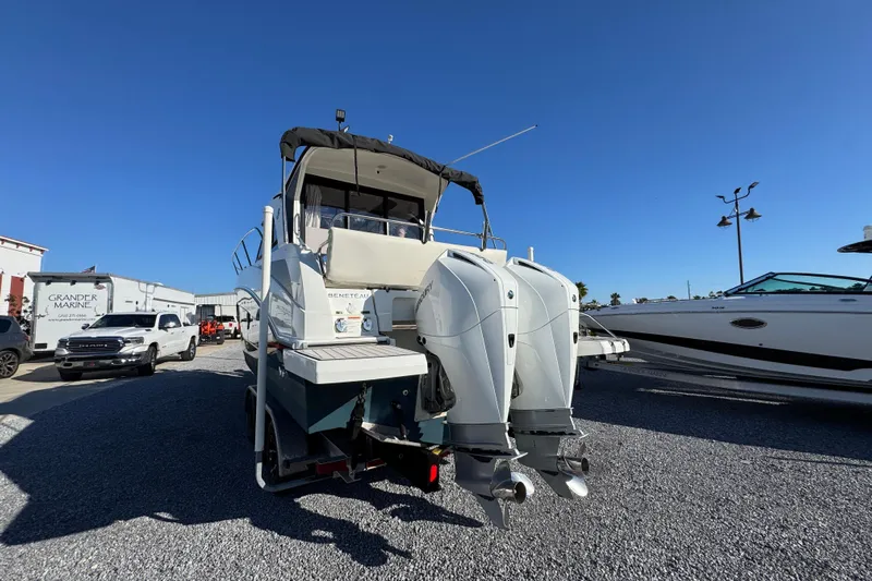  Yacht Photos Pics 2020 Beneteau Antares 27 boat with dual outboard motors in a marina setting.
