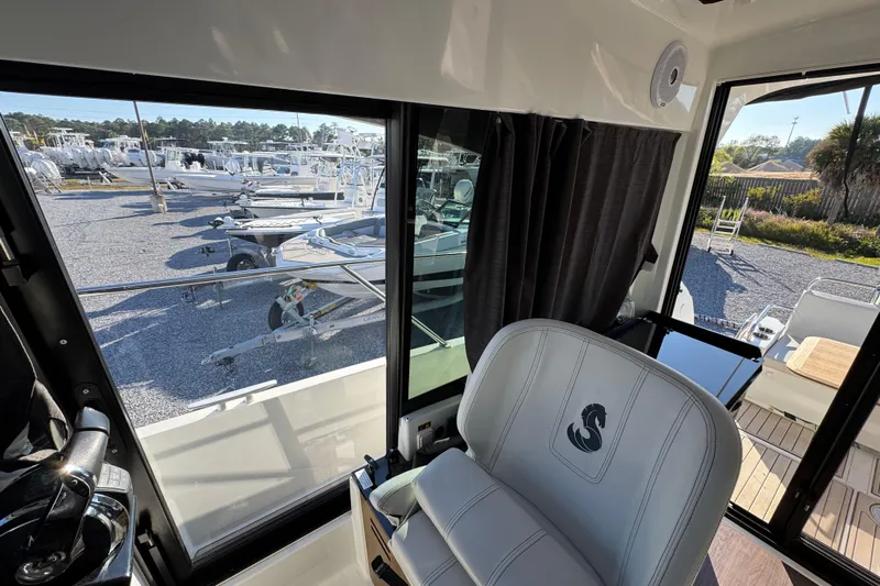  Yacht Photos Pics Interior view of 2020 Beneteau Antares 27 boat with marina background.