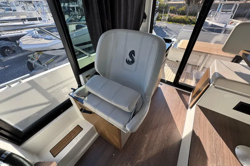  Yacht Photos Pics Captain's chair on 2020 Beneteau Antares 27 boat, featuring sleek design and comfortable seating.
