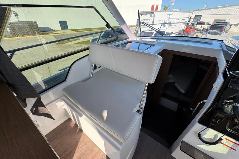  Yacht Photos Pics Interior view of 2020 Beneteau Antares 27 boat, featuring seating and cabin entrance.