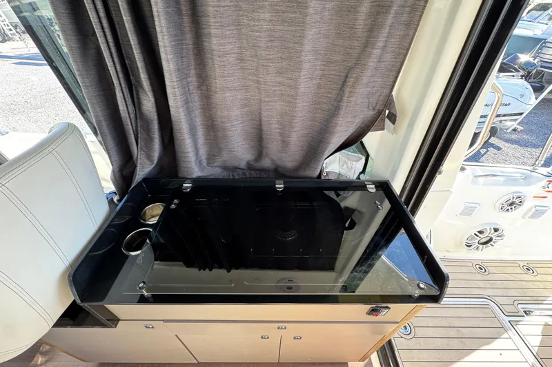  Yacht Photos Pics Interior of 2020 Beneteau Antares 27 with sleek black countertop and cup holders.