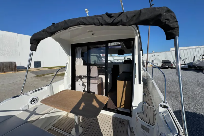  Yacht Photos Pics 2020 Beneteau Antares 27 boat with outdoor seating and canopy, docked at marina.