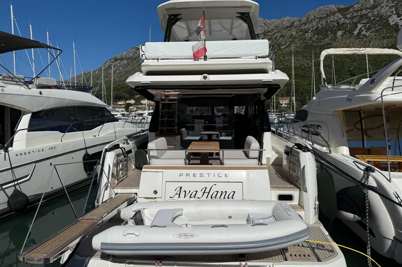 Ava Hana Yacht Photos Pics Luxury 2024 Prestige F4.9 yacht docked, featuring spacious deck and inflatable boat.