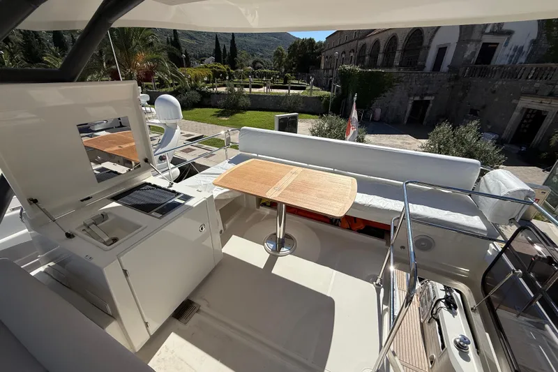 Ava Hana Yacht Photos Pics Luxurious 2024 Prestige F4.9 yacht deck with seating and dining area.