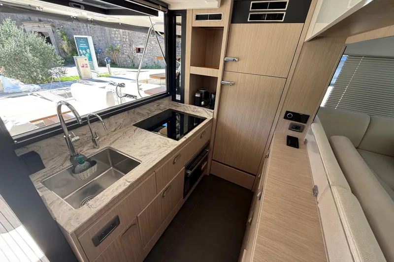 Ava Hana Yacht Photos Pics Modern kitchen interior of 2024 Prestige F4.9 yacht with sleek design and amenities.