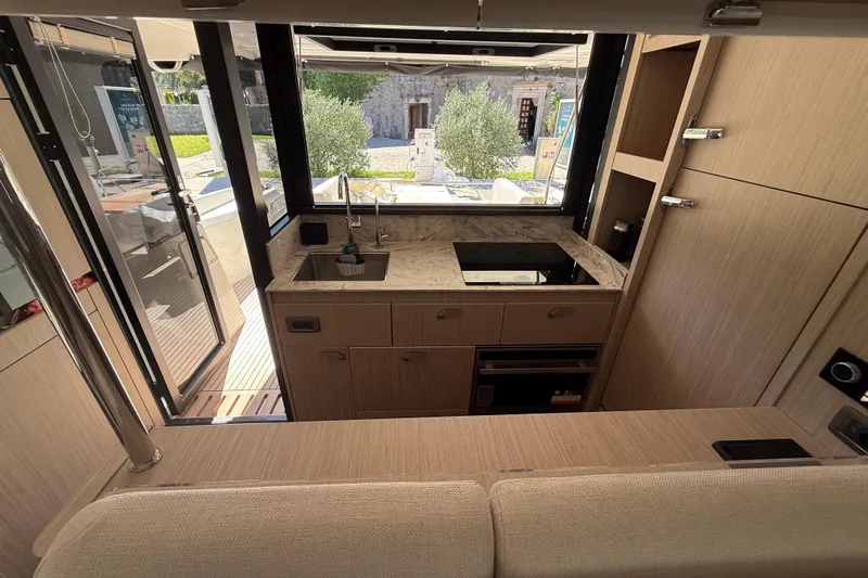 Ava Hana Yacht Photos Pics Modern kitchen interior of 2024 Prestige F4.9 yacht with sleek design and ample natural light.