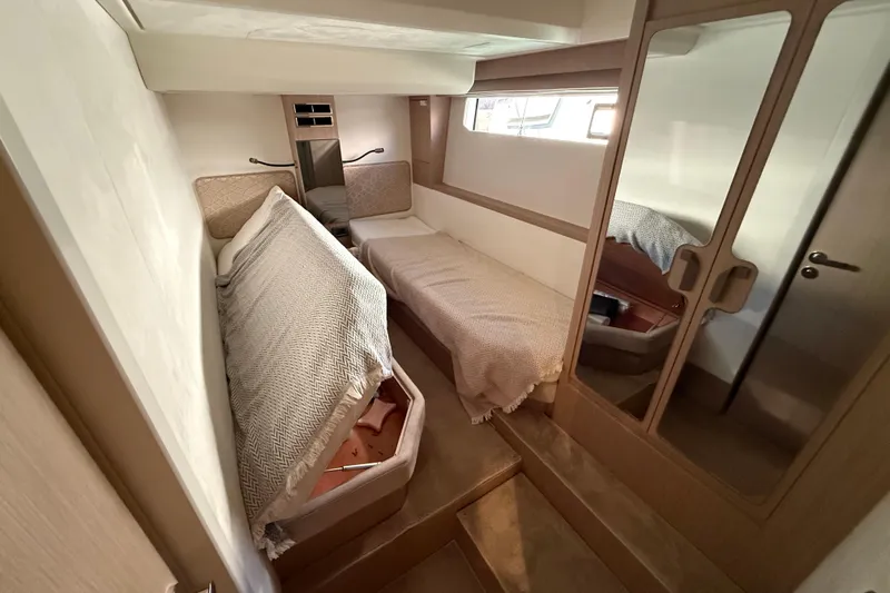 Ava Hana Yacht Photos Pics 2024 Prestige F4.9 yacht cabin interior with twin beds and mirrored closet.