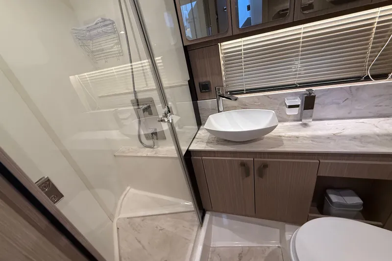 Ava Hana Yacht Photos Pics Modern bathroom in 2024 Prestige F4.9, featuring sleek fixtures and marble surfaces.