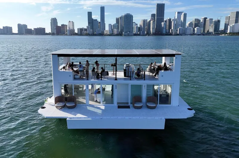  Yacht Photos Pics Floating luxury home, Arkup 50, on water with city skyline in background, 2025 model.