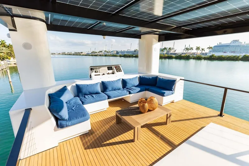  Yacht Photos Pics Luxurious Arkup 50 yacht deck with blue seating, solar panels, and waterfront view, 2025 model.
