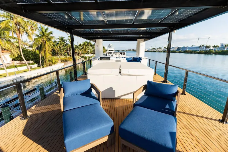  Yacht Photos Pics Luxury Arkup 50 yacht deck with blue loungers, solar panels, and waterfront view, 2025 model.