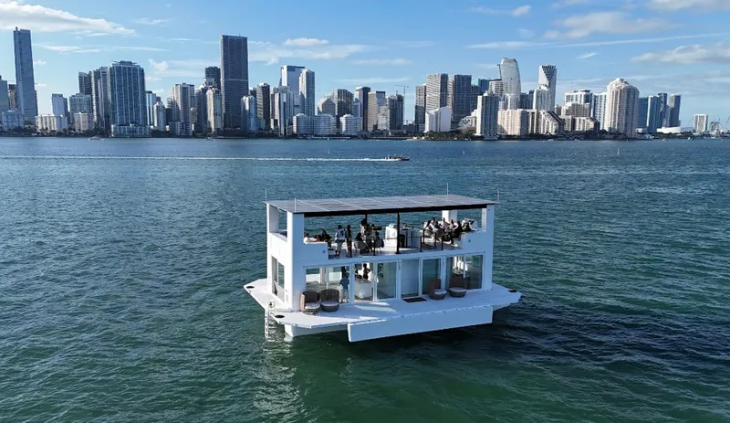  Yacht Photos Pics Floating modern Arkup 50 houseboat on water with city skyline in background, 2025 model.