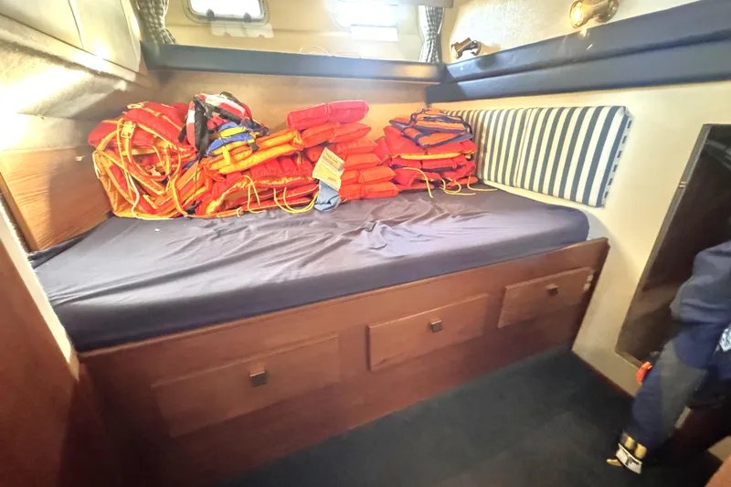 Yacht Photos Pics 1989 Bayliner 4588 Pilothouse cabin with life jackets on bed.