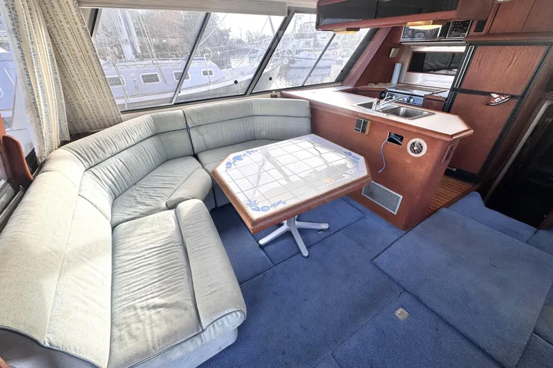  Yacht Photos Pics 1989 Bayliner 4588 Pilothouse interior with cozy seating and kitchenette.