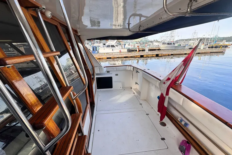  Yacht Photos Pics 1989 Bayliner 4588 Pilothouse yacht deck with wooden accents, docked at marina.
