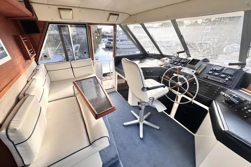  Yacht Photos Pics 1989 Bayliner 4588 Pilothouse interior with helm, seating, and panoramic windows.