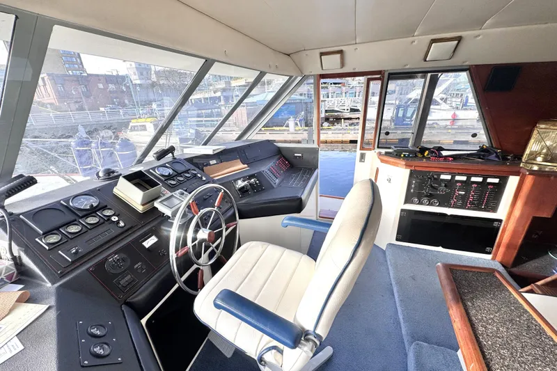  Yacht Photos Pics 1989 Bayliner 4588 Pilothouse interior with steering wheel and control panel.